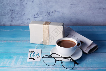 质地蓝色的父亲节快乐一杯咖啡带礼物盒和眼镜知识图片