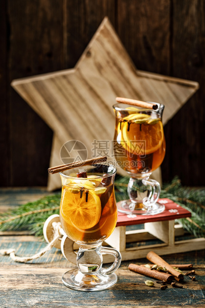 新年冬季假日和圣诞节的热饮加柠檬卡多姆肉桂和三丁香辣椒茶和朗姆酒鸡尾香料树葡萄图片