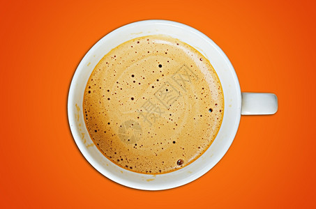 粮食卡布奇诺咖啡杯和橙色背景的豆子最佳有香味的图片