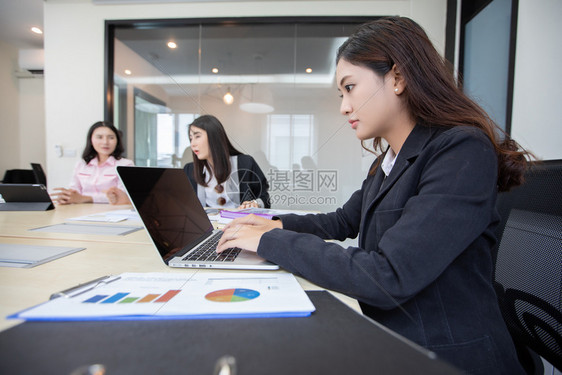 为了纸亚洲女商人认真对待工作并使用笔记本供商业伙伴在会议上讨论文件和想法研讨会上论文件和意见药片图片