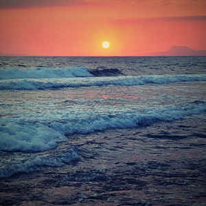 地平线全景晚上美丽的夏天日落在海滩上惊人的景色与海浪和太阳反射背景假期和度旅行的背景希腊克里特岛图片