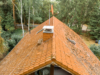 动图雨飞德国检查一个独立房屋的红色瓦式顶并装有覆盖烟囱和卫星天线背景