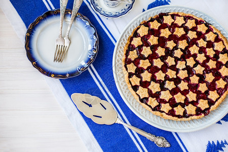 木制的传统盘子上美味自制的酸樱桃派碗杯加奶油甜点叉和木板桌上整块布料经典食谱从盘子上方美味自制土酸樱桃派看脆皮图片