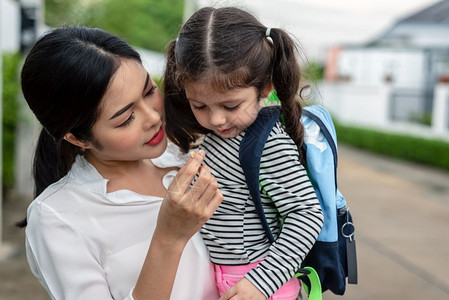 孩子们喜悦妈在上学前给女儿吃点心然后去上学回到校教育概念家庭甜蜜的和幸福庭主题午餐图片