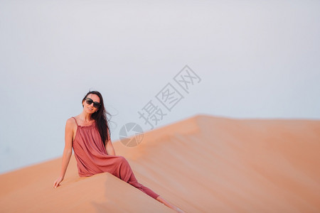美丽的女在阿拉伯联合酋长国沙漠中的丘享受假期在阿拉伯联合酋长国RubalKhali沙漠的丘中女孩在生态喜欢阿比图片