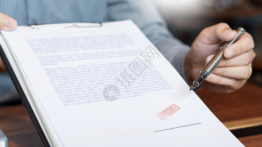 金融的雄心勃签署商业文件字笔和经批准在证明合同协议律师亲手概念文件上盖印的签名喷泉笔和经批准的证书合同协议工作背景图片