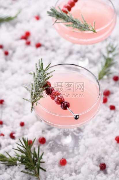 开胃酒马提尼庆祝的Goblet与cranberryMargarita与糖果红莓迷迭香完美鸡尾酒为圣诞派对图片