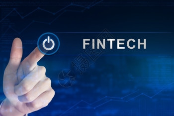 商业区块链手点击Fintech或背景模糊的金融技术按钮或金融技术按钮键平台图片