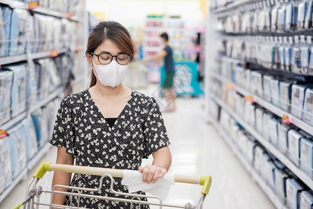 女人用湿巾清洁购物车表面图片