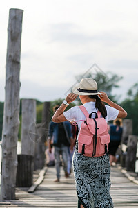 日落时年轻妇女在UBeein桥上行走亚洲旅者在缅甸阿马拉普缅甸的陆地标志附近旅行游客吸引东南亚旅游的概念很受欢迎帕努瓦木制的为了图片