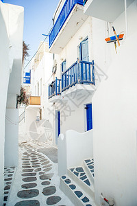 墙米科诺斯夏天岛上狭窄的街道希腊有蓝色阳台楼梯漂亮的建筑外观具有基克拉迪风格图片