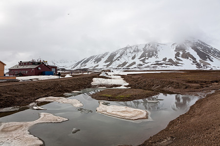 奥勒松斯瓦尔巴德群岛NyAlesundSvalbard岛挪威雪山和斯瓦尔巴德群岛NyAlesund气象站的雾天雪山和气象站景观水图片