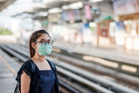 青年女性在火车站戴着口罩图片