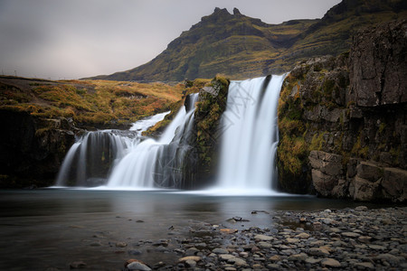 吸引力夏天河冰岛在北部自然景观中拍摄瀑布和著名山峰柯尔丘费斯福和柯克朱弗图片