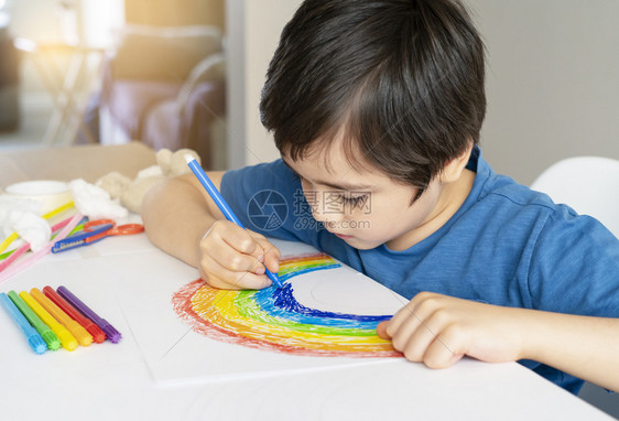 白色的詹克Kid使用白纸上DIY儿童艺术的蓝色笔画彩虹在放学时留家中庭学校教育概念社会媒体预防冠状运动等利用蓝笔画彩虹给孩子看白图片