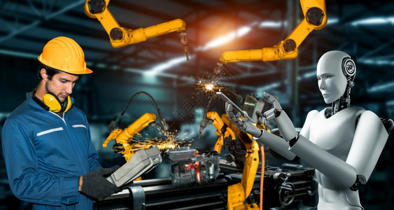 机械化工业器人与类工在未来厂中协同作业革命和自动化制造过程的人工智能概念机械化工业器人和类工在未来厂中协同作创新自动的聪明图片
