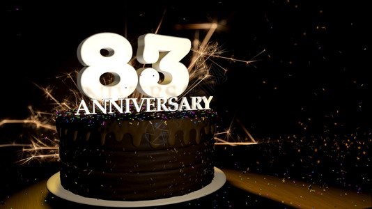 83卡圆形巧克力蛋糕装饰着蓝色红黄绿的糖衣杏仁木桌上有白色数字背景