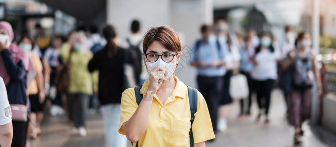 青年女游客在公共火车站戴防护口罩图片