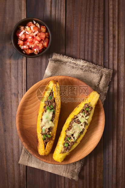 辣椒芭蕉在中美洲一种叫CanoadePlatanoPlantanoPlantainCanoe的传统菜盘配有番茄和洋葱沙拉在深木上图片