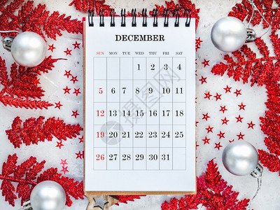 笔记本数字人们圣诞树的日历和绿枝躺在白桌上从面看特写没有人为假期做准备的概念祝贺亲戚朋友和同事圣诞树的日历和绿枝图片