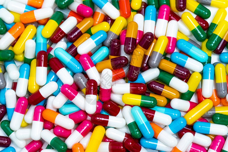 顶视图五颜六色的胶囊丸全框一堆鲜艳的胶囊丸制药工业用于医疗保健的药产品物开发概念健康预算和政策蓝色的药剂学为了图片