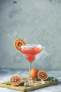 液体轮缘红橙玛格丽塔鸡尾酒加龙舌兰三立秒橙汁压碎的冰和玻璃边缘一些盐装饰在地底深浅的柑橘场地图片