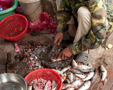 亚洲人女士厨师柬埔寨暹粒2013年2月日身份不明的高棉妇女在2013日在柬埔寨暹粒的食品市场清洁和卖鱼街头食品市场是亚洲流行的传图片