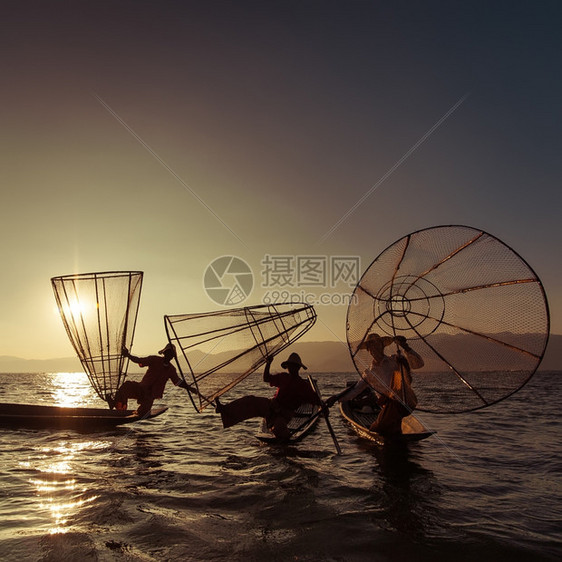 缅甸河旅行目的地缅甸竹船上渔夫以传统方式与手工制作的Inle网湖捕鱼使用手工制造的Inle湖缅甸旅游目的地捕捉美丽皮艇图片