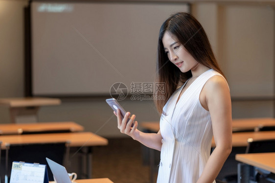 亚洲女商人穿着休闲西装在现代办公室或会议使用智能手机和办公用品商务和工人概念研讨会房间女图片