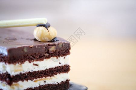 巧克力蛋糕在木制桌上有白奶油的巧克力蛋糕关闭写作空间选择焦点模糊糖果黑色的白图片