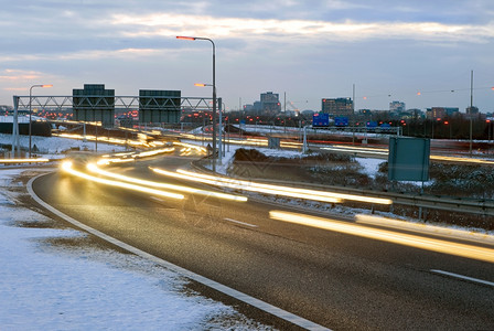 行动冬天季晚上在高速公路交叉口经过的车厢公共汽图片