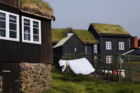最小的法罗语基础图象式的住宅区与典型黑色铁草屋顶在Streymoy岛法罗群首都Torshavn老城Tinganes上建有石块地的图片