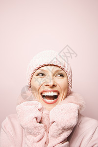 欢笑的女人衣服手摸中年微笑中年人照片外套粉色手套帽子图片