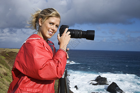 拿着相机的女人观光观众三脚架爱好海岸视觉水平女性娱乐海洋图片
