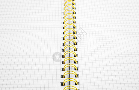 特写螺旋绑定的笔记本宏观字帖练习簿平方零售工作簿活页夹设备黄色书脊图片