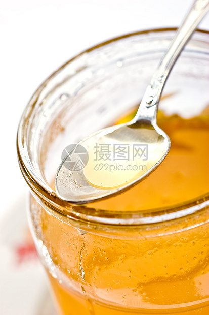 蜂蜜蜂蜜滴矿物玻璃状食物勺子白色玻璃图片
