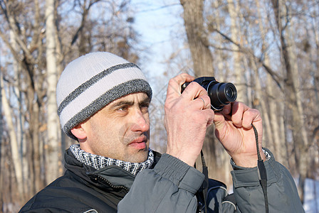 男子在冬天拍下照片天空快照爱好专注男人男性镜片职业成人木头图片
