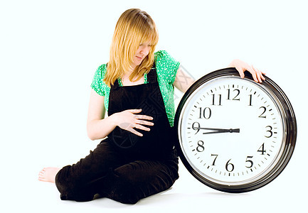 怀孕妇女有时钟母亲女孩腹部婴儿时间黑色妈妈绿色白色女性图片