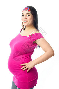 快乐的孕妇裙子微笑喜悦母亲婴儿幸福粉色生活父母腹部图片