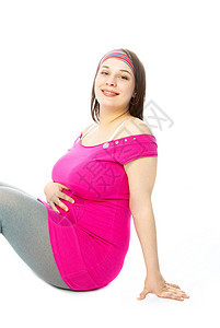快乐的孕妇微笑地面裙子女性化生活喜悦粉色腹部白色女孩图片