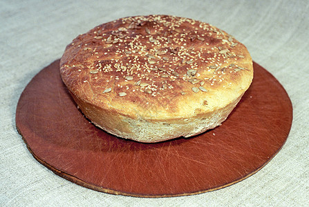 圆形面包帆布白色尖刺棕色农业食物种子裂纹芝麻烹饪图片