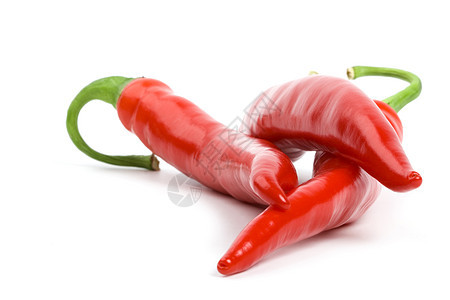 三只红辣椒食物白色香料蔬菜红色绿色活力水果宏观辣椒图片