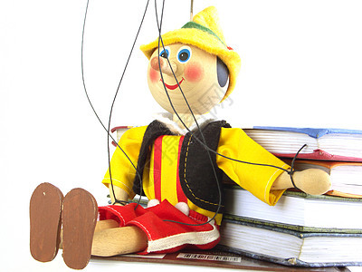木偶和书红色木头学校黑色娃娃教育概念性黄色玩具图片