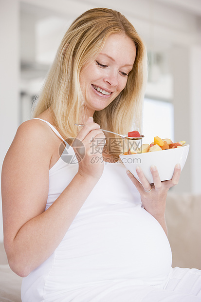 带一碗水果沙拉微笑的孕妇家庭孕产怀孕食物早餐妈妈饮食小吃家长女性图片