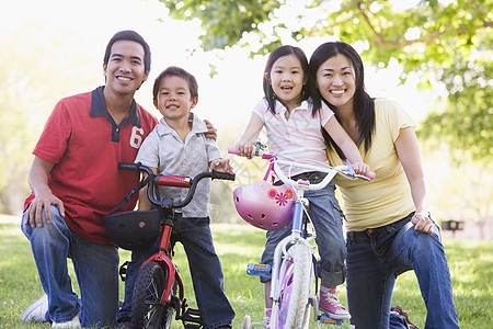 有孩子的家庭在户外的自行车上微笑图片