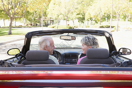 夫妇在可兑换汽车上微笑驾驶水平两个人摩托车敞篷车女士女性男性退休农村图片