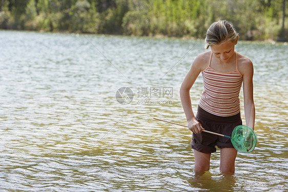 女孩在湖中玩耍女性钓鱼孩子们渔网童年装备享受孩子兴趣女孩们图片