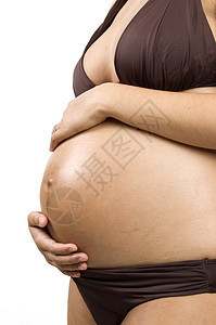 怀孕30周的怀孕少女抱着她的肚子女孩妈妈希望妻子女士辉光海岸腹部木乃伊庆典图片