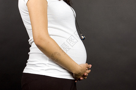 怀孕30周的怀孕少女抱着她的肚子妈妈海岸木乃伊生活妻子身体女孩辉光女性母亲图片