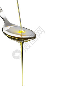 汤匙上含橄榄油的橄榄油敷料沙拉白色饮食烹饪味道银器美食黄色勺子图片